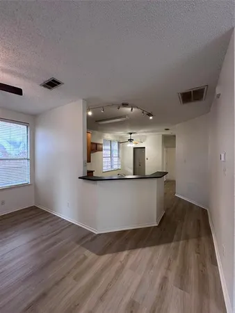 a view of living room with wooden floor and window