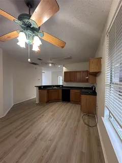 a view of kitchen with cabinets and wooden floor