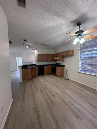 a view of kitchen and a wooden floor