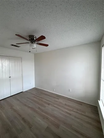 a view of a room with wooden floor