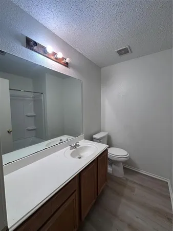 a bathroom with a sink a toilet and a mirror