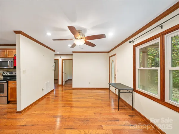 a view of an empty room with wooden floor