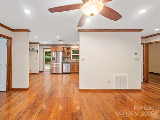 a kitchen with stainless steel appliances granite countertop a refrigerator and wooden cabinets