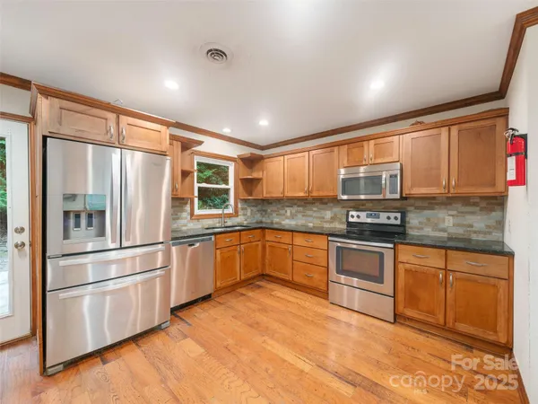 a view of kitchen with furniture and refrigerator