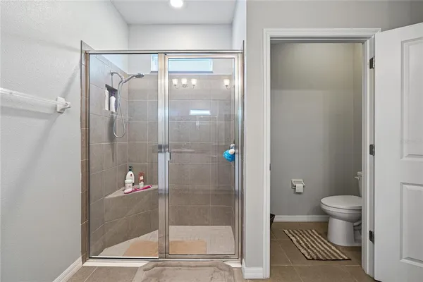 a bathroom with a shower and a toilet
