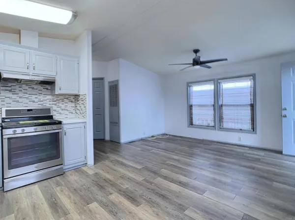 a view of a kitchen with a stove cabinets and wooden floor