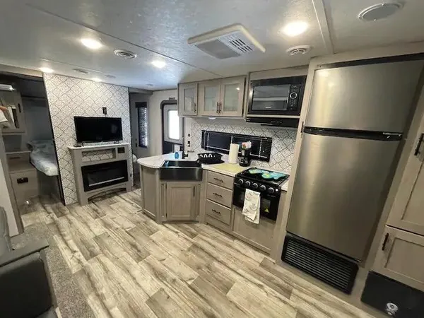 a kitchen with stainless steel appliances and refrigerator