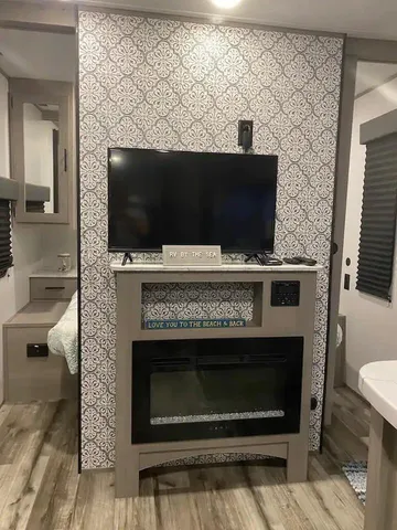 a living room with a fireplace and a flat screen tv