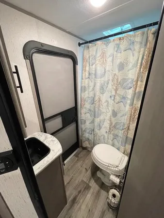 a bathroom with a toilet and a shower
