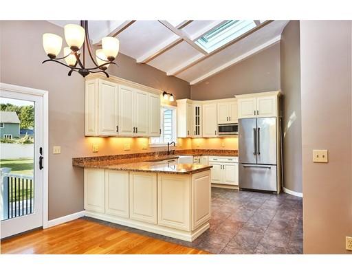 17 Rustic Lane Reading, MA 01867 - Photo 11 of 40 a kitchen with stainless steel appliances granite countertop a sink a stove a refrigerator and island