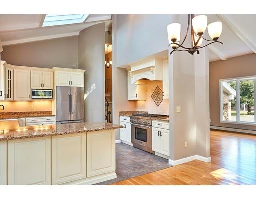 17 Rustic Lane Reading, MA 01867 - Photo 12 of 40 a kitchen with stainless steel appliances granite countertop a stove a sink and a refrigerator