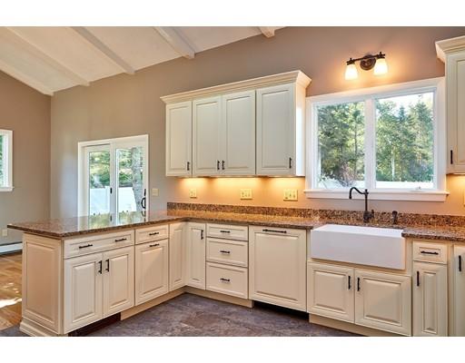 17 Rustic Lane Reading, MA 01867 - Photo 13 of 40 a kitchen with kitchen island granite countertop a sink window and cabinets