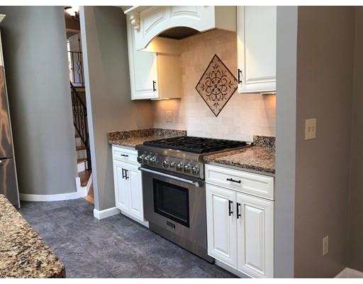17 Rustic Lane Reading, MA 01867 - Photo 14 of 40 a kitchen with stainless steel appliances granite countertop a stove and a microwave