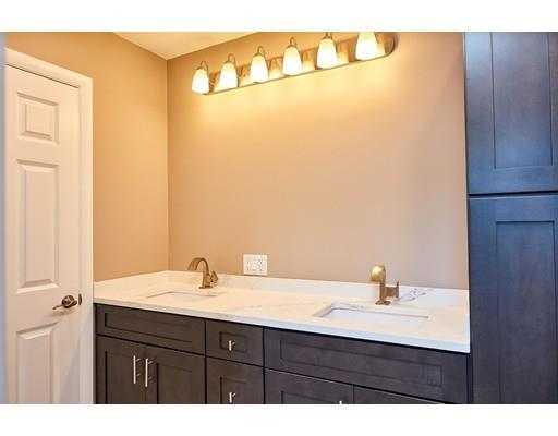 17 Rustic Lane Reading, MA 01867 - Photo 17 of 40 a bathroom with a sink and a mirror