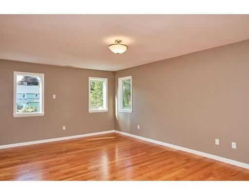 17 Rustic Lane Reading, MA 01867 - Photo 19 of 40 a view of an empty room with window and wooden floor