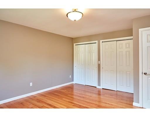 17 Rustic Lane Reading, MA 01867 - Photo 22 of 40 a view of an empty room with wooden floor and fan
