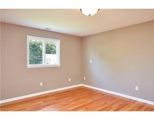 17 Rustic Lane Reading, MA 01867 - Photo 24 of 40 an empty room with wooden floor and windows