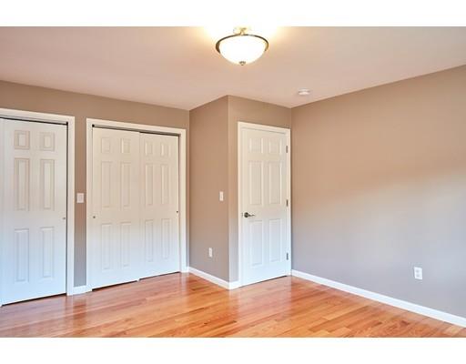 17 Rustic Lane Reading, MA 01867 - Photo 26 of 40 a view of an empty room with wooden floor and fan