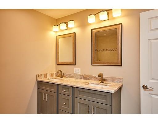 17 Rustic Lane Reading, MA 01867 - Photo 28 of 40 a bathroom with a sink and a mirror