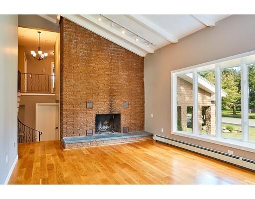17 Rustic Lane Reading, MA 01867 - Photo 7 of 40 a view of empty room with a fireplace and floor to ceiling window