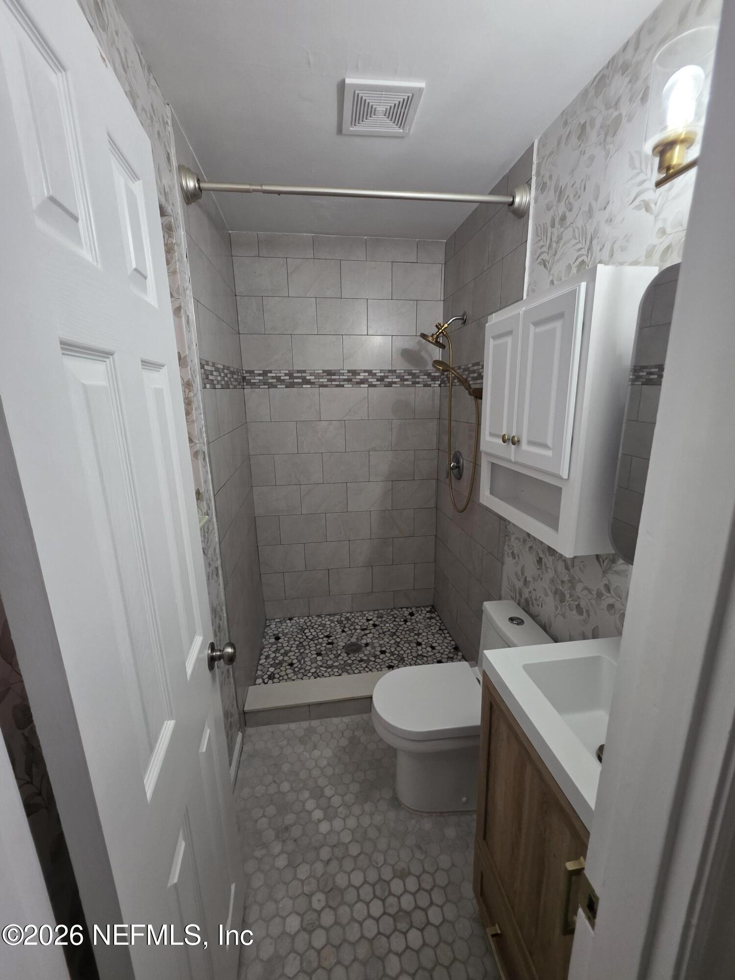 3616 Toledo Road Jacksonville, FL 32217 - Photo 26 of 34 a bathroom with a sink toilet and shower