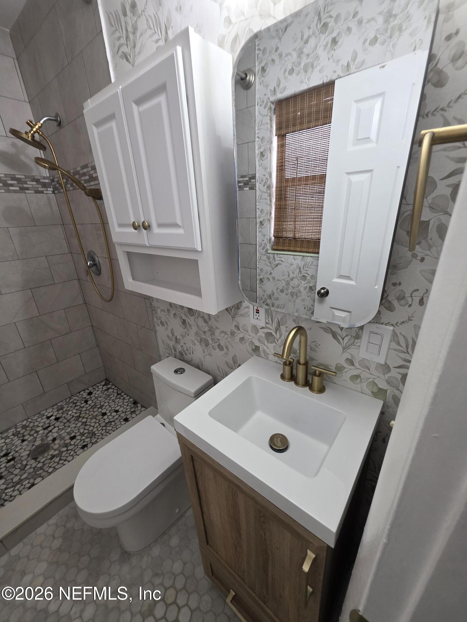3616 Toledo Road Jacksonville, FL 32217 - Photo 27 of 34 a bathroom with a sink a toilet and a mirror