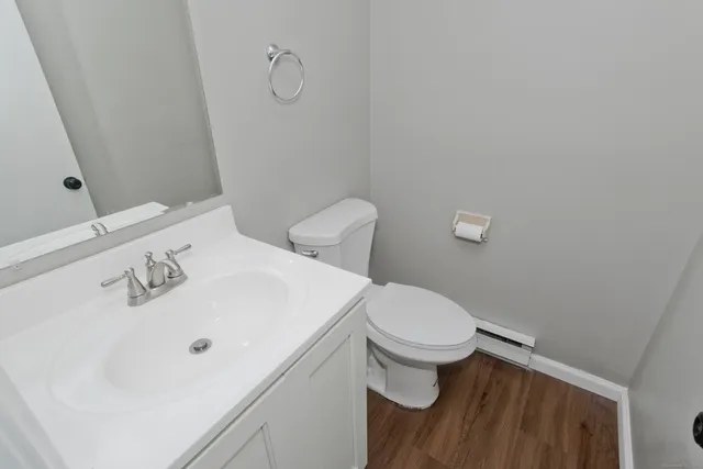 a white toilet sitting next to a bathroom sink