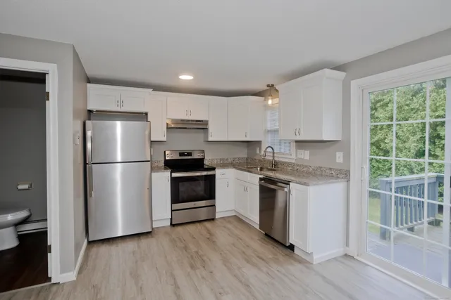 a kitchen with a refrigerator stove and sink
