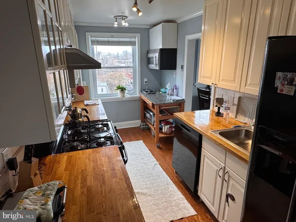 a kitchen with a sink appliances and cabinets