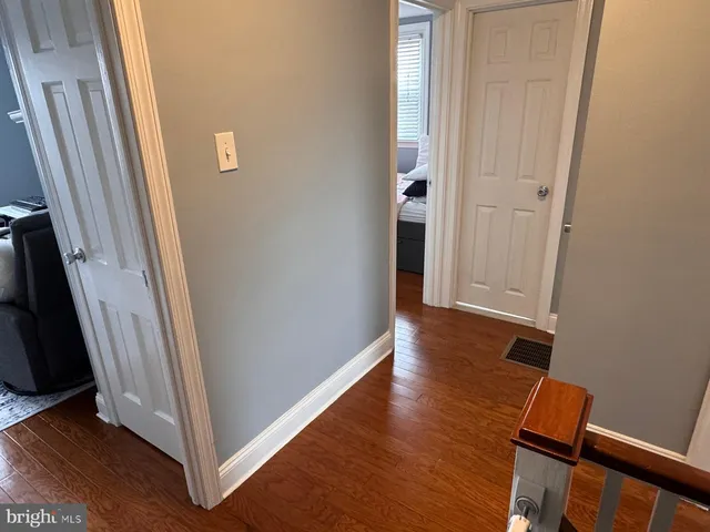 an empty room with wooden floor and a window