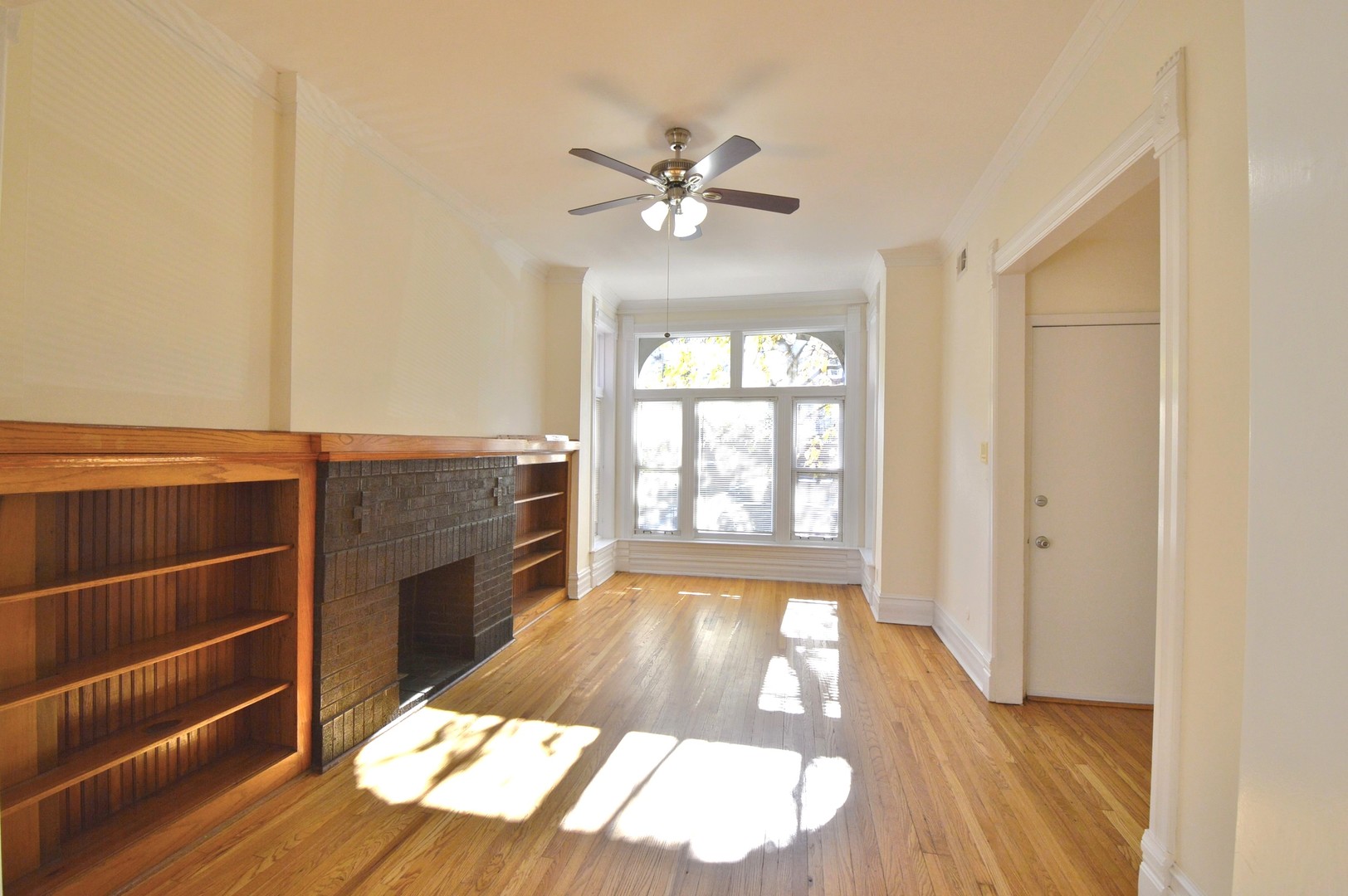 1924 West Crystal Street, Unit 3 Chicago, IL 60622 - Photo 2 of 13 a view of an empty room with wooden floor and a window