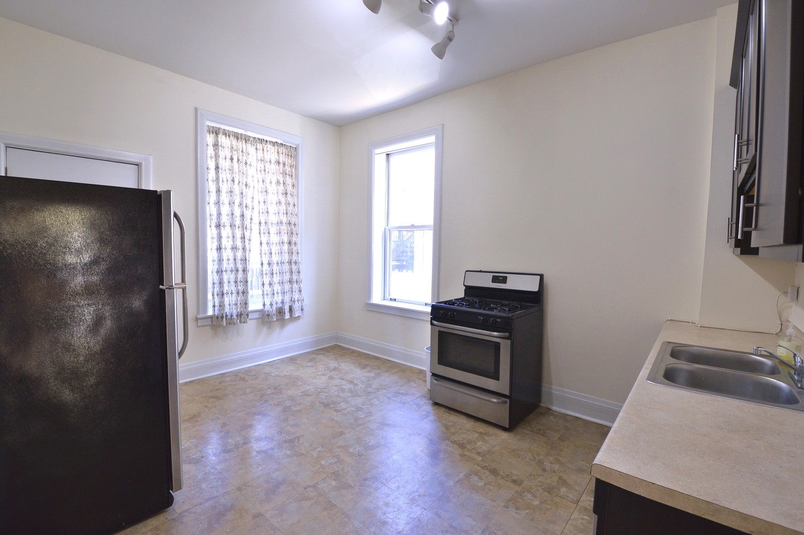 1924 West Crystal Street, Unit 3 Chicago, IL 60622 - Photo 4 of 13 a kitchen with a refrigerator and a stove top oven