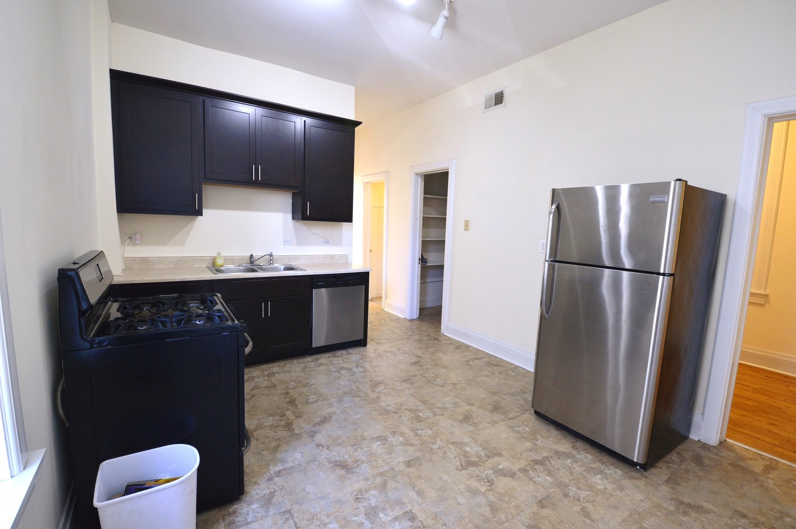 1924 West Crystal Street, Unit 3 Chicago, IL 60622 - Photo 5 of 13 a kitchen with stainless steel appliances a refrigerator and a sink