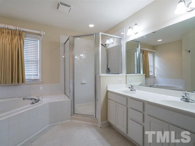 4528 Mistiflower Drive Raleigh, NC 27606 - Photo 13 of 25 a bathroom with a tub double vanity sink and mirror