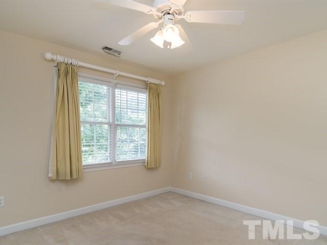 4528 Mistiflower Drive Raleigh, NC 27606 - Photo 15 of 25 an empty room with a window and a fan