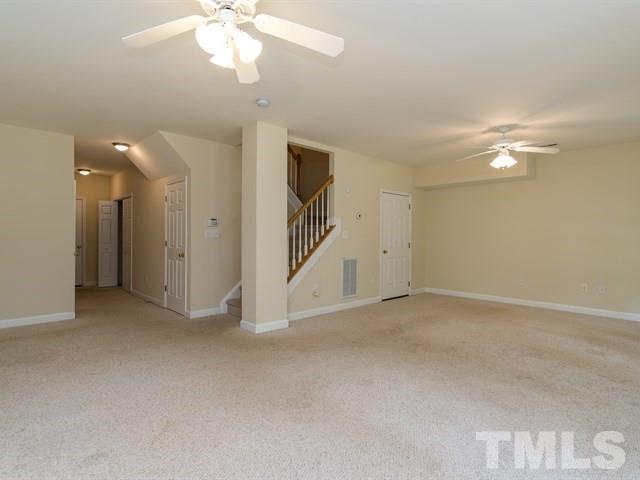 4528 Mistiflower Drive Raleigh, NC 27606 - Photo 20 of 25 an empty room with fan and windows