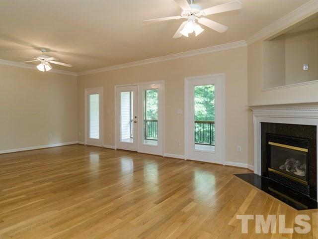 4528 Mistiflower Drive Raleigh, NC 27606 - Photo 3 of 25 a view of an empty room with wooden floor and a window