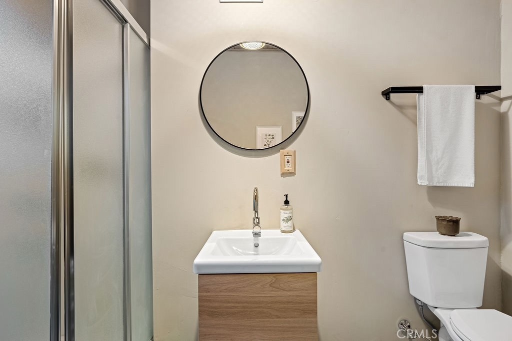 989 Calanda Drive Crestline, CA 92325 - Photo 11 of 30 a bathroom with a sink a toilet and a mirror