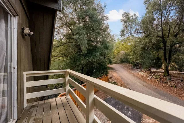 a view of balcony with wooden floor and fence