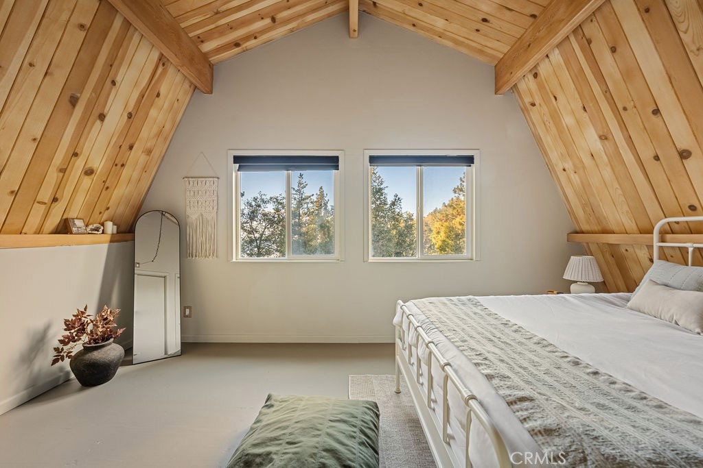 989 Calanda Drive Crestline, CA 92325 - Photo 20 of 30 a bedroom with a bed and a chandelier