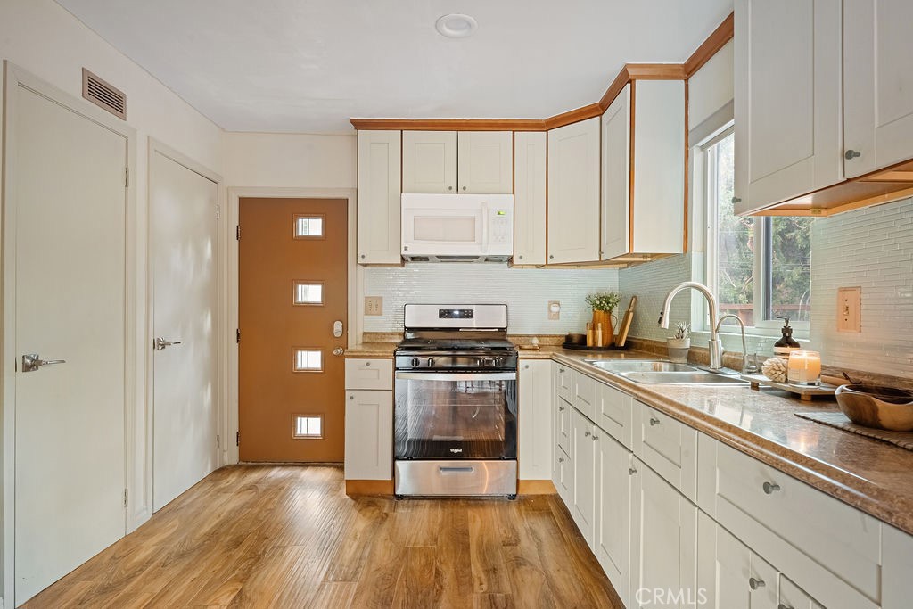 989 Calanda Drive Crestline, CA 92325 - Photo 5 of 30 a kitchen with a sink a stove and cabinets