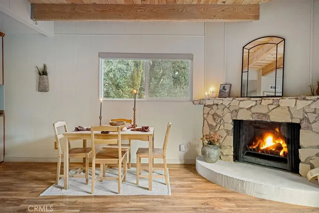 a view of a livingroom with a fireplace and window