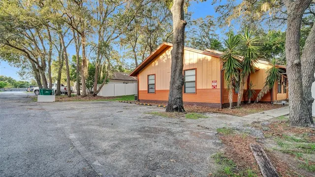 a view of a house with a yard and trees