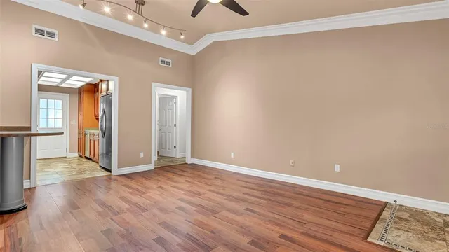 wooden floor in an empty room with a window