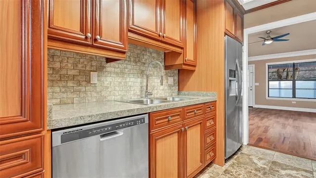 a kitchen with stainless steel appliances granite countertop a refrigerator and a sink