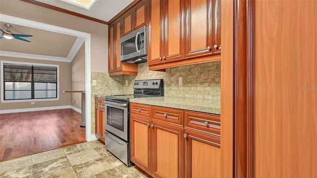 a kitchen with stainless steel appliances granite countertop a refrigerator and cabinets