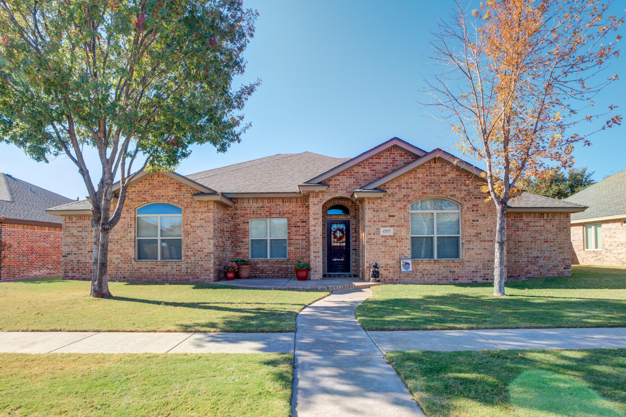 4707 106th Street Lubbock, TX 79424 - Photo 1 of 51 a front view of a house with garden
