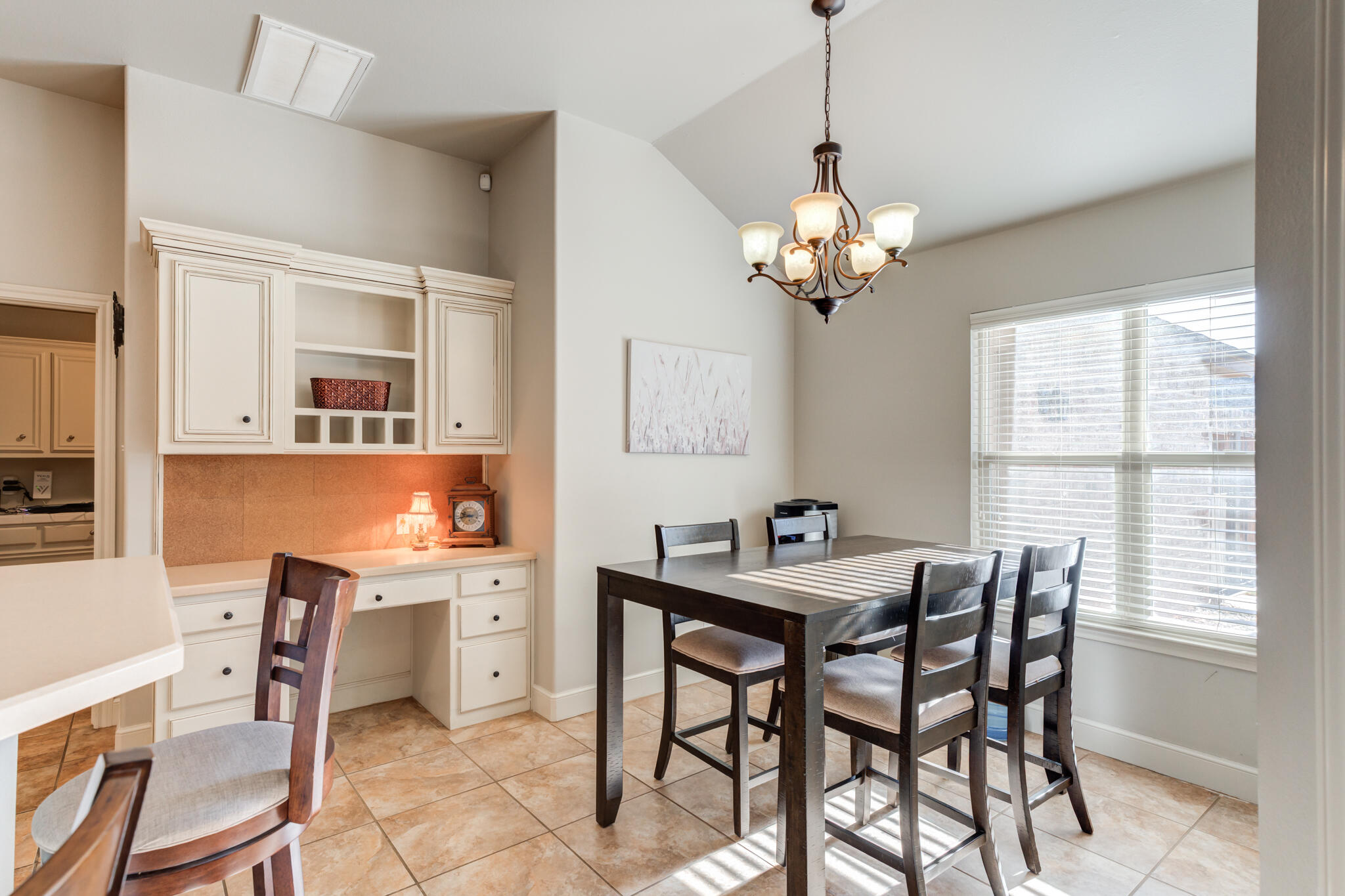 4707 106th Street Lubbock, TX 79424 - Photo 14 of 51 a view of a dining room with furniture a chandelier and a window