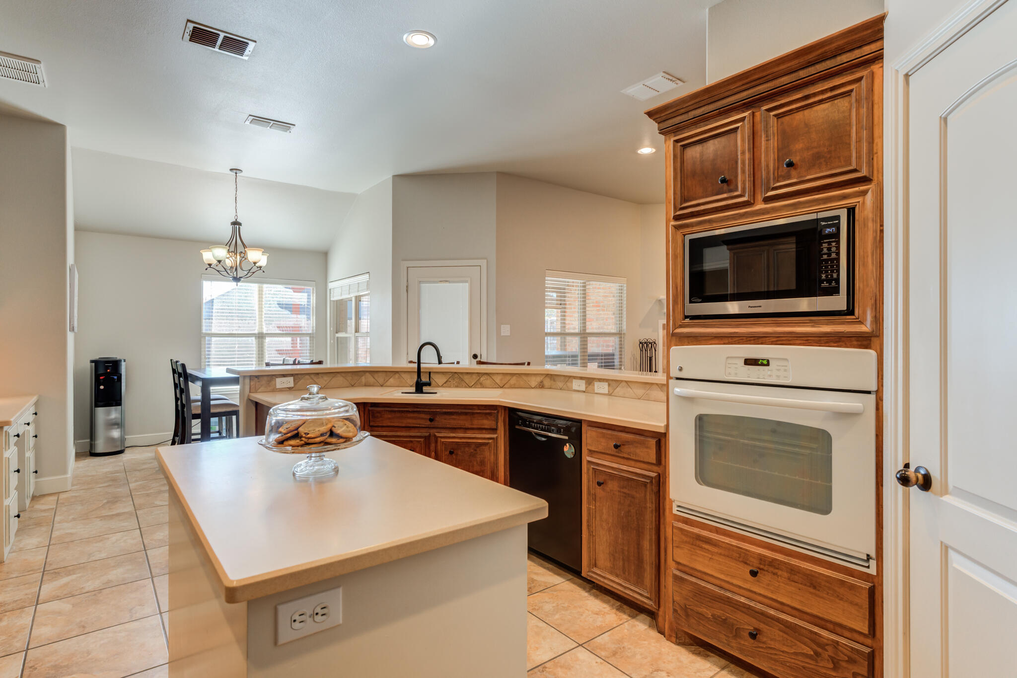 4707 106th Street Lubbock, TX 79424 - Photo 19 of 51 a kitchen with a stove a sink and a microwave