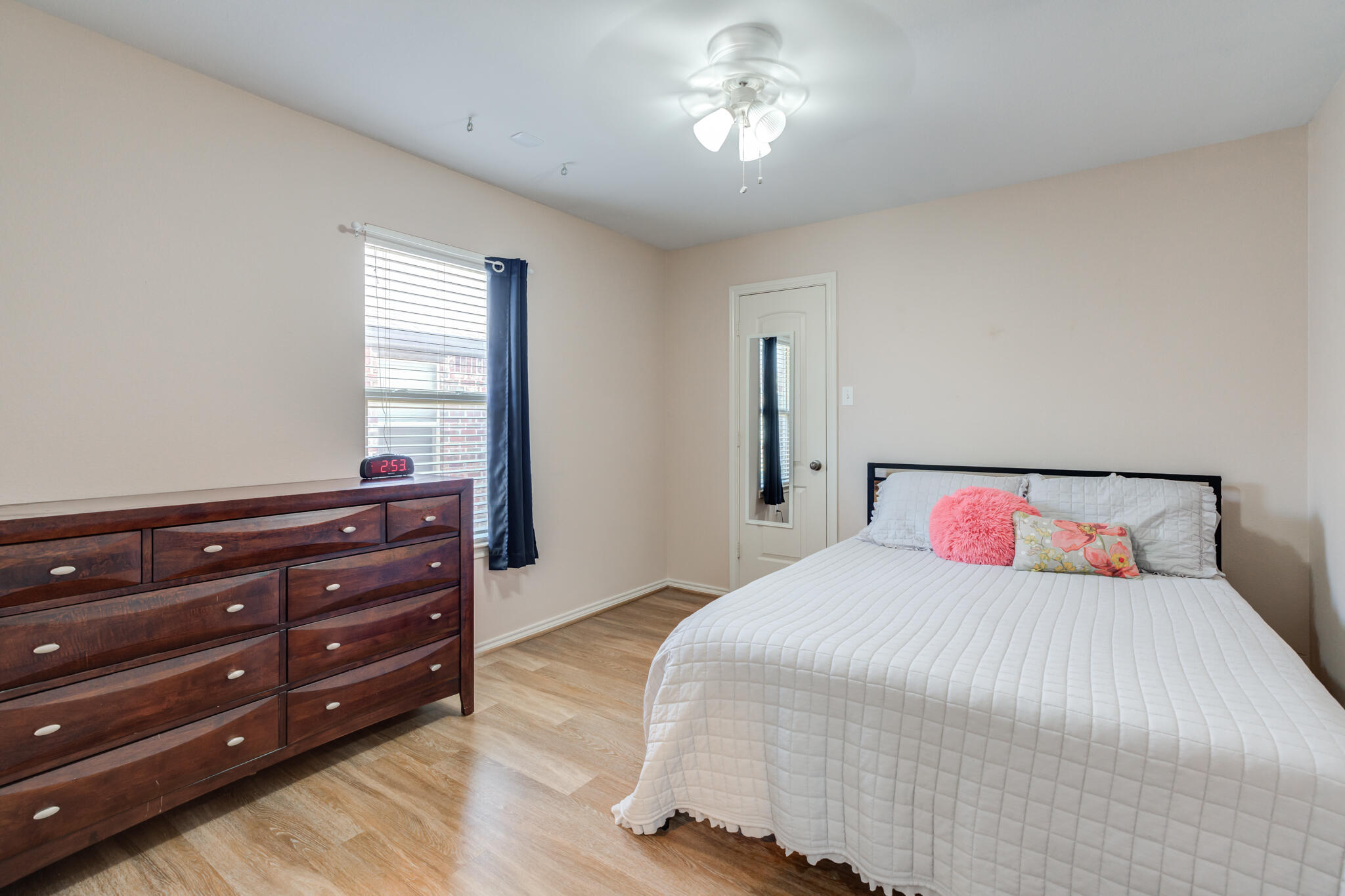 4707 106th Street Lubbock, TX 79424 - Photo 39 of 51 a bedroom with a large bed and a dresser